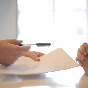 crop businessman giving contract to woman to sign stockpack pexels